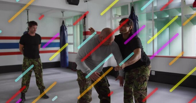 Instructor stepping behind participant applying rear lock, showing martial arts leverage technique