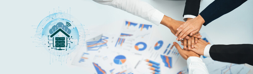 Obraz premium A diverse group of professionals joining hands to symbolize teamwork and collaboration, surrounded by graphs and digital elements representing data analysis and market growth. Trope