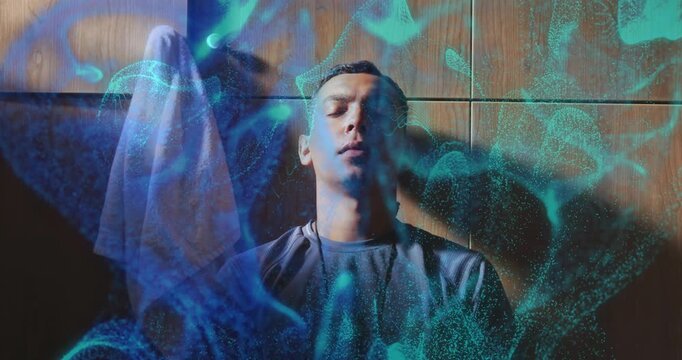 Upon faint blue waves appearing, man sitting against wall, cyan tech particles swirling for focus
