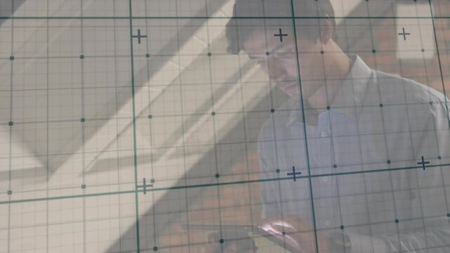 Man tapping tablet screen, initiating animated grid overlay on transparent board and analyzing data