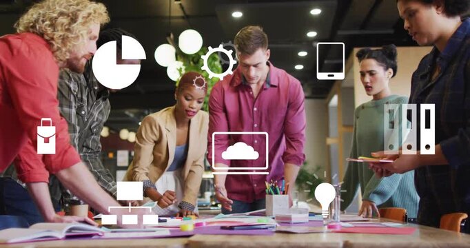 Designers collaborating as man moving paper triggers icons pulsing prototypes for digital planning