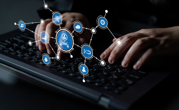 A close-up of hands typing on a laptop keyboard surrounded by CRM icons, showcasing the integration of technology in managing customer relationships effectively. Tessel