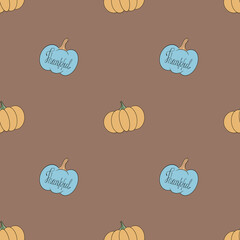Seamless pattern with blue and yellow pumpkins