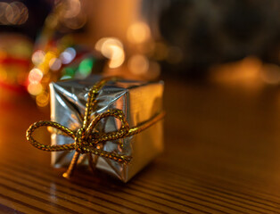 Luxury golden gift box against a seasonal backdrop.Christmas and New Year holiday concept.
