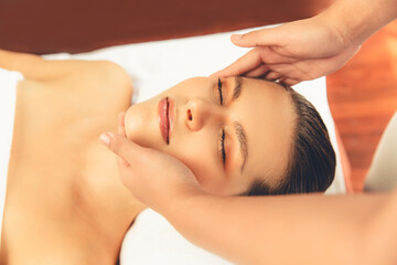 Closeup woman enjoying relaxing anti-stress head massage and pampering facial beauty skin...