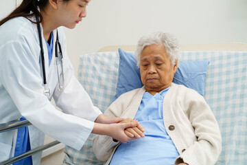 Asian doctor checking and treat elderly woman patient health in hospital.