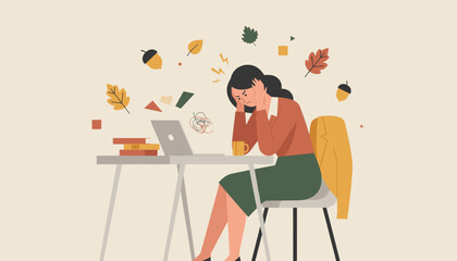Burnout and work stress in the fall An overwhelmed woman holding her head at an office desk