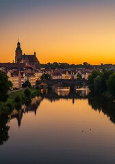 Scenic Riverfront Cityscape at Sunset with Golden Hour Glow and Reflections.