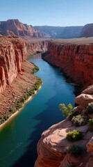 Vast Orange Canyon Carved By A Deep Blue River Under A Bright Sunny Sky With Scattered Greenery Along The Rocky Edges