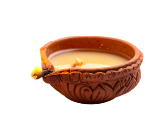 Lit earthen lamp with embossed pattern, filled with liquid, burning brightly against a black background