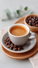 Fototapeta premium Styled Flat Lay Of Roasted Coffee Beans With Espresso In A Cup On A Wooden Tray With Green Leaves