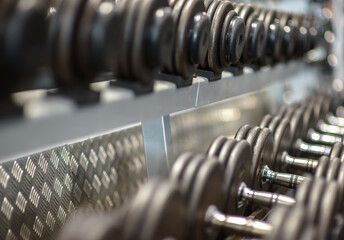 Gym weight lifting equipment, dumb bells on a rack - horizontal