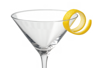 Martini glass with a yellow lemon peel twist on the rim, prepared for a classic cocktail or drink. Transparent background