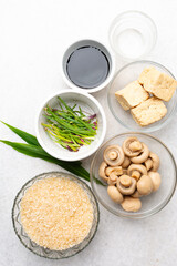 overhead view of mise en place of ingredients for making vegan claypot rice, process of making claypot rice