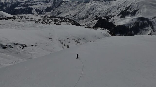 Aerial view of man is freeriding in Caucasus mountains, Gudauri, Georgia.