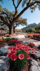 Vibrant Red Wildflowers Bloom Along a Stone Path Beside a Majestic Oak Tree and a Serene River Under a Clear Blue Sky