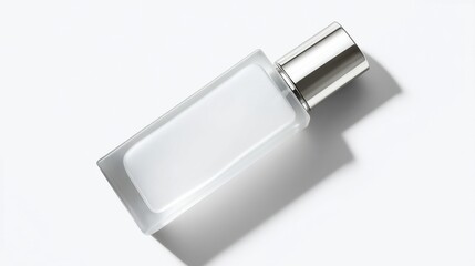 A rectangular frosted glass bottle lies horizontally on a clean white surface,