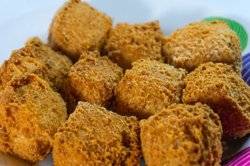 Close-up of crispy golden fried tofu cubes on a plate. Traditional Asian snack with crunchy texture, perfect vegetarian street food served hot and freshly fried