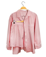 Red striped pajama isolated on white background. Home sleepwear woman pale pink color hanging on...