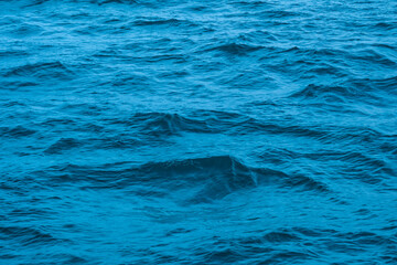 Fototapeta premium Deep sea waves. The surface of the blue sea has ripples and light reflecting on the sea.
