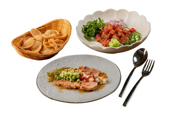 Delicious food arrangement including chips, diced tomatoes, and a main course displayed