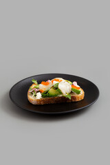 Open Sandwich with Cream Cheese, Avocado, Hotate, Radit, Tomato and Tobiko Eggs.