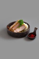 Tonkatsu or Crispy fried pork with Curry rice on grey background.