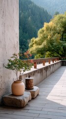 Tibetan prayer wheel rests on stone next to potted plant beside stone wall with trees and mountains in background scenic cultural setting
