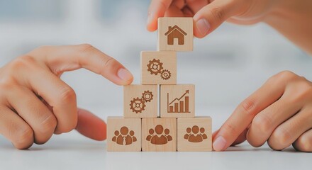 Hands arranging wooden blocks with various symbols, representing business and teamwork concepts.