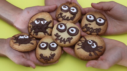 cookies with chocolate in childrens hands, close up. Top view
