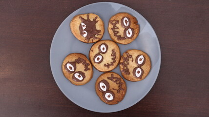 Tasty homemade cookies on plate, top view. natural food for kids. biscuits decorated with chocolate, top view