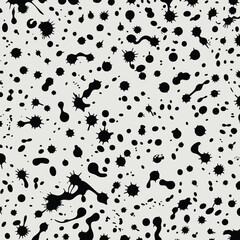 Seamless pattern with black ink blots and splatters on light gray background for artistic designs and modern textures