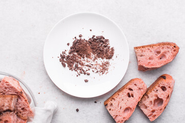 Overhead view of strawberry and chocolate sourdough, top view of pink and chocolate artisan bread on a white background, open crumb artisan bread