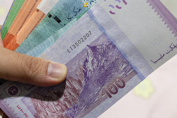 Man hand with Malaysia Bank Note Ringgit Malaysia