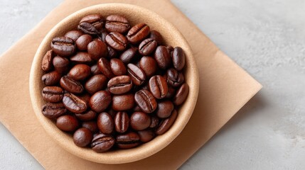 Fototapeta premium Rustic Rustic Flat Lay Of Roasted Coffee Beans In A Bowl On Brown Paper With Textured Background Overhead View