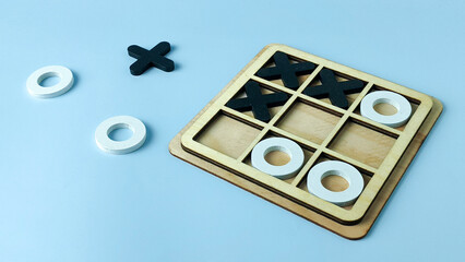 Making a Critical Decision: Wooden Tic-Tac-Toe Game with Pieces Off the Board for Strategic Choice