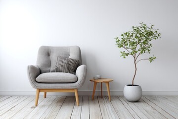 A gray armchair sits next to a small table and a potted plant.