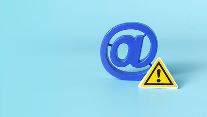 Blue At Symbol and Caution Sign Representing Email Risk, Cyber Security Threat, Spam Danger, and Online Communication Warning