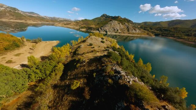 Autumn colors around mountain reservoir aerial view