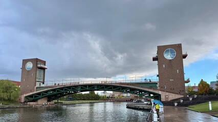 Modern bridge over calm water on a cloudy day, travel and architecture concept