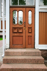 Old decorative front door with woodwork and glass. 
