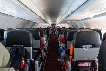 Passengers sitting in airplane awaiting takeoff for flight