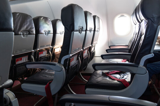 Passengers sitting in airplane awaiting takeoff for flight