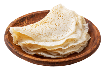 Rolled Brazil tapioca sweet crepe with airy texture on wooden plate, isolated on white transparent background, concept of traditional South American Cuisine