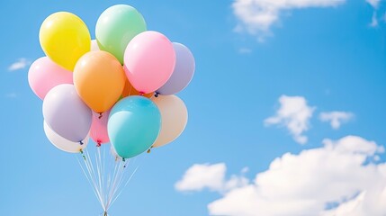 Colorful Balloons Floating Against a Bright Blue Sky with Fluffy White Clouds
