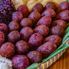 Close-up macro of timus ubi ungu, traditional Indonesian fried snack made from purple sweet potato. Authentic Asian dessert with natural purple color and crispy texture.