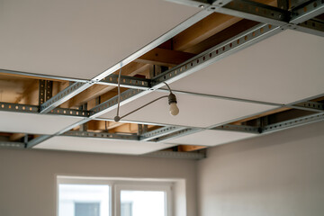 Fototapeta premium Suspended ceiling construction with exposed metal grid and light fixture