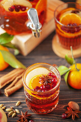 Homemade hot alcohol cranberry orange apple cider punch with cinnamon sticks, anise star and spices. Thanksgiving drink