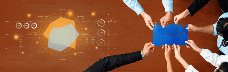 A diverse group of individuals engaged in collaborative problem solving using puzzles and data visuals on a modern office table, showcasing teamwork dynamics. Trope