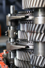Detailed stack of helical gears and shafts from a disassembled vehicle transmission, showcasing the mechanical complexity and precision engineering of the components.